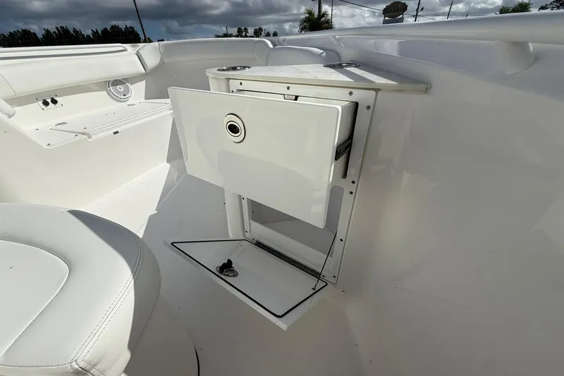 Slide: The Image of 2021 Edgewater 262CC boat interior with storage compartment and seating. - 27
