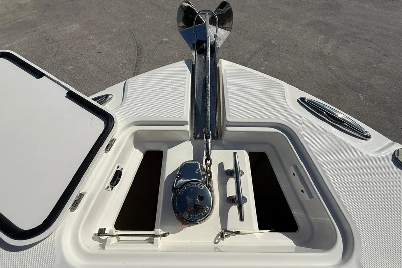 Slide: The Image of Bow anchor compartment of 2021 Edgewater 262CC boat, featuring stainless steel hardware. - 31