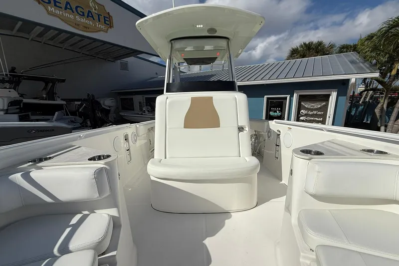 Slide: The Image of 2021 Edgewater 262CC boat interior with white seating at Seagate Marine Sales. - 35