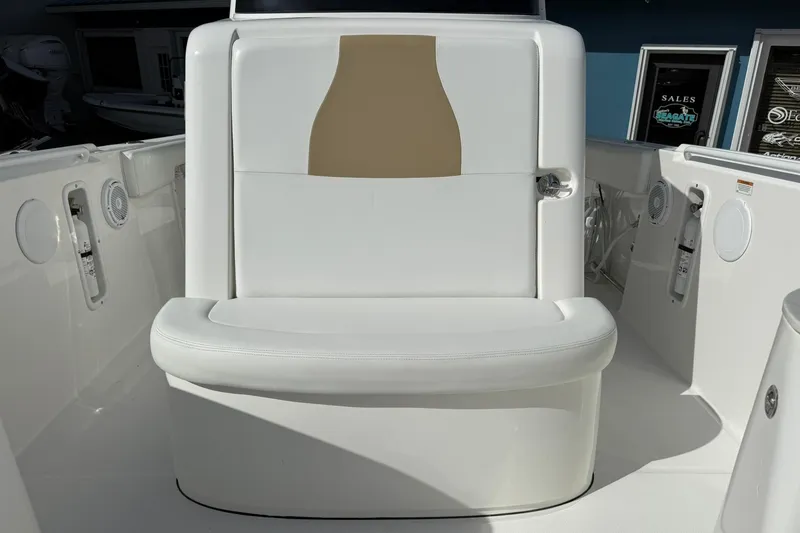 Slide: The Image of 2021 Edgewater 262CC boat interior with white cushioned seating and modern design. - 37