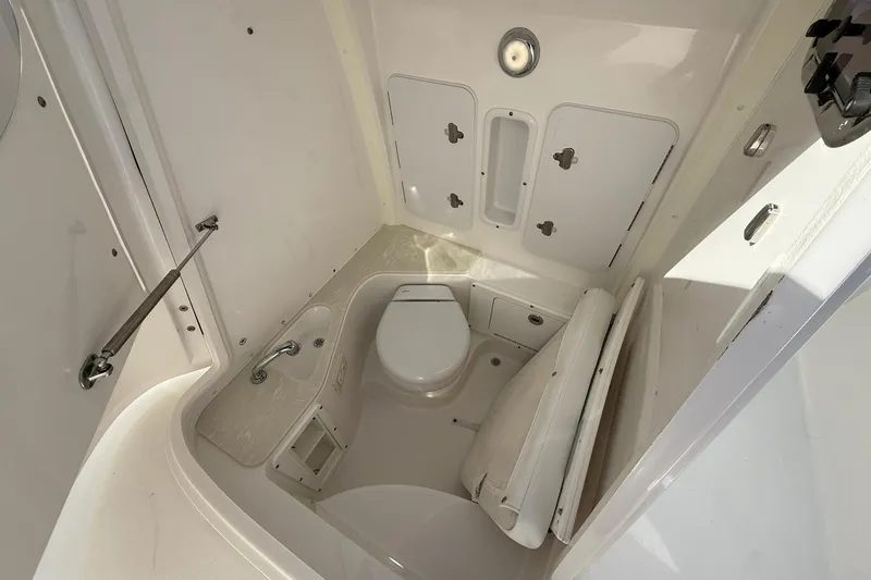 Slide: The Image of 2021 Edgewater 262CC boat interior bathroom with toilet and sink. - 39