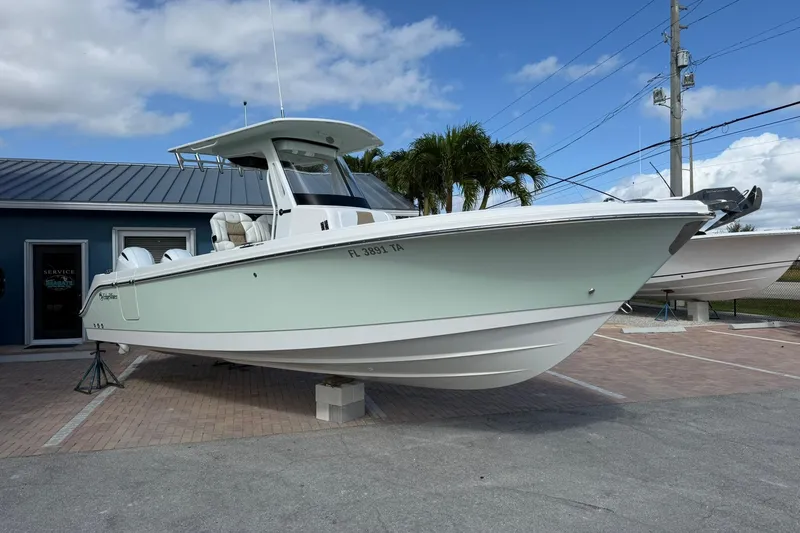 Slide: The Image of 2021 Edgewater 262CC boat displayed outdoors, with a light blue hull and modern design. - 6