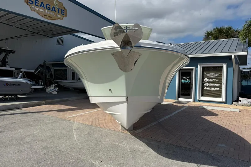 Slide: The Image of 2021 Edgewater 262CC boat displayed at Seagate Marine Sales, sunny day. - 7
