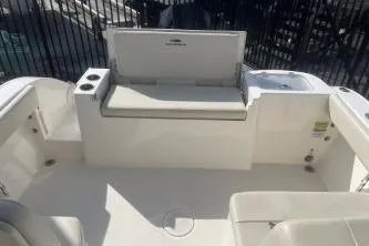 Slide: The Image of 2023 Cobia 220 Dual Console boat interior with seating and storage. - 11
