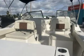 Slide: The Image of 2023 Cobia 220 Dual Console boat interior with seating and cup holders. - 6