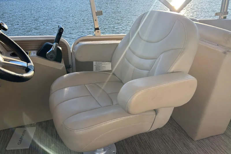 Slide: The Image of Captain's chair on 2022 Godfrey Sweetwater 2286 C pontoon boat, overlooking water. - 14