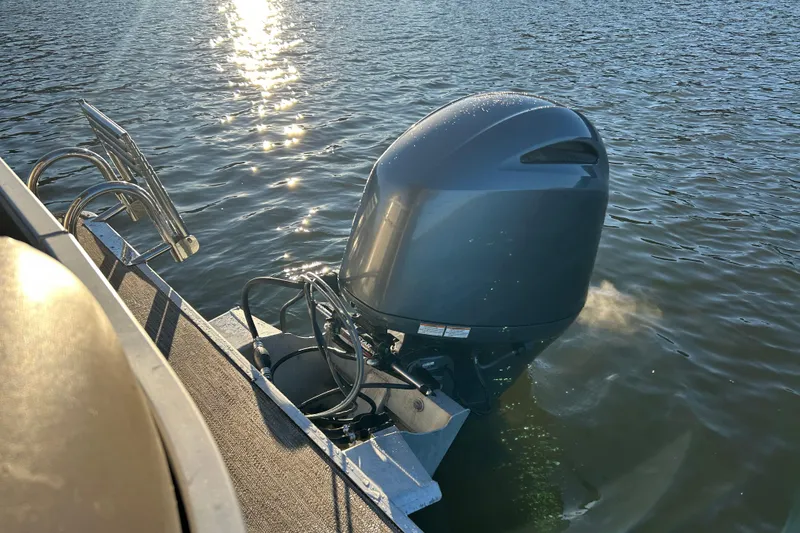 Slide: The Image of 2022 Godfrey Sweetwater 2286 C pontoon boat with outboard motor on water. - 17