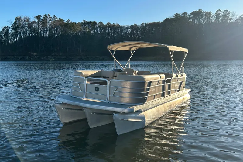 Slide: The Image of 2022 Godfrey Sweetwater 2286 C pontoon boat on a serene lake. - 3