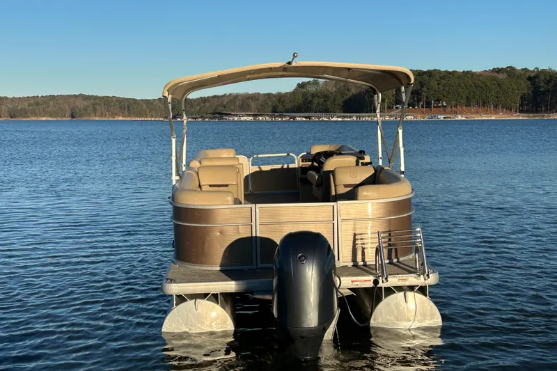 Slide: The Image of 2022 Godfrey Sweetwater 2286 C pontoon boat on a serene lake. - 7