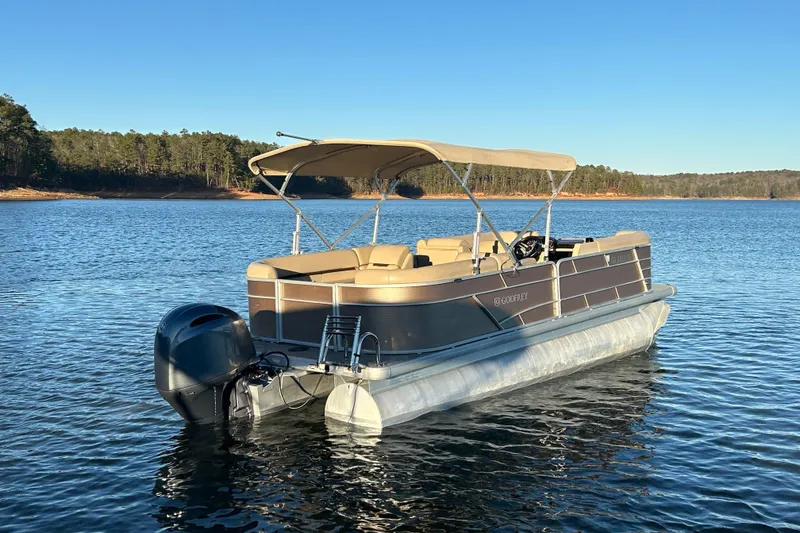Slide: The Image of 2022 Godfrey Sweetwater 2286 C pontoon boat on a serene lake. - 8