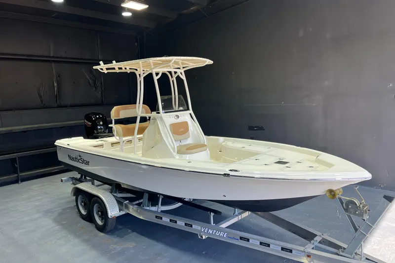 The Image of 2023 NauticStar 215 XTS boat on trailer in indoor setting. - 1