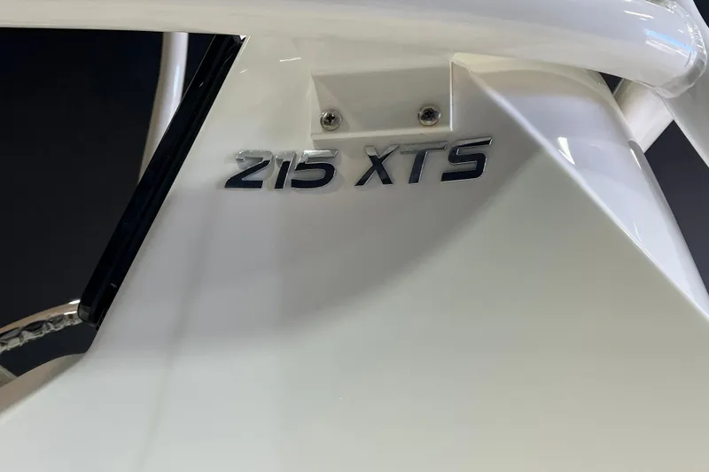 Slide: The Image of 2023 NauticStar 215 XTS boat emblem on a sleek white surface. - 10
