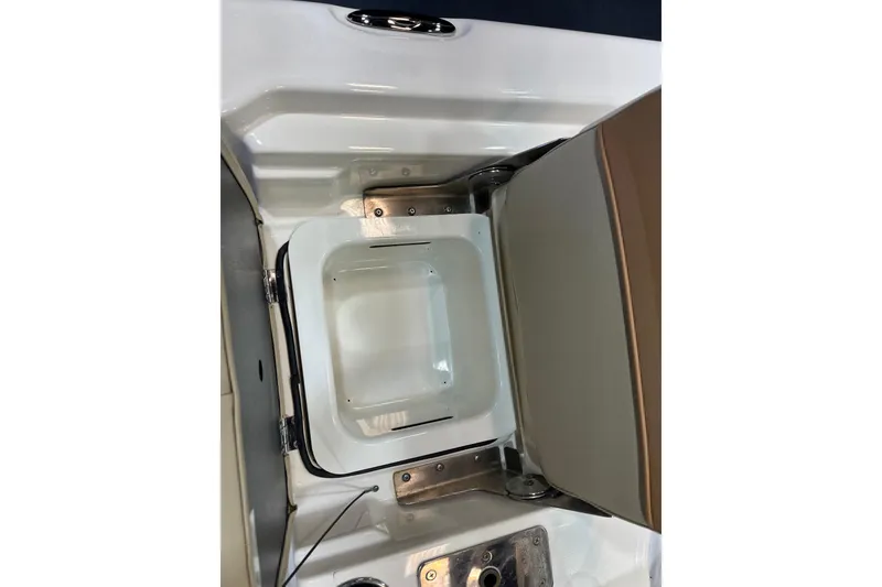 Slide: The Image of 2023 NauticStar 215 XTS boat storage compartment with open lid. - 12