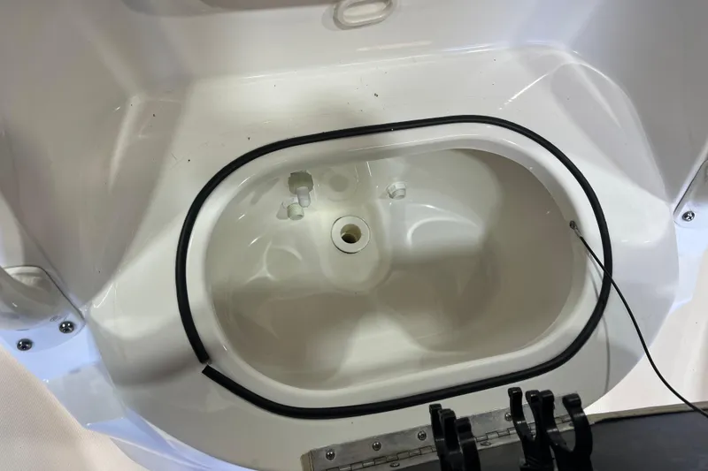 Slide: The Image of 2023 NauticStar 215 XTS boat livewell interior, white finish, oval shape. - 13