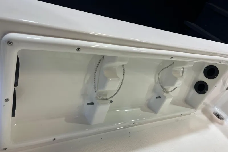 Slide: The Image of 2023 NauticStar 215 XTS boat interior detail with rod holders and storage compartments. - 16