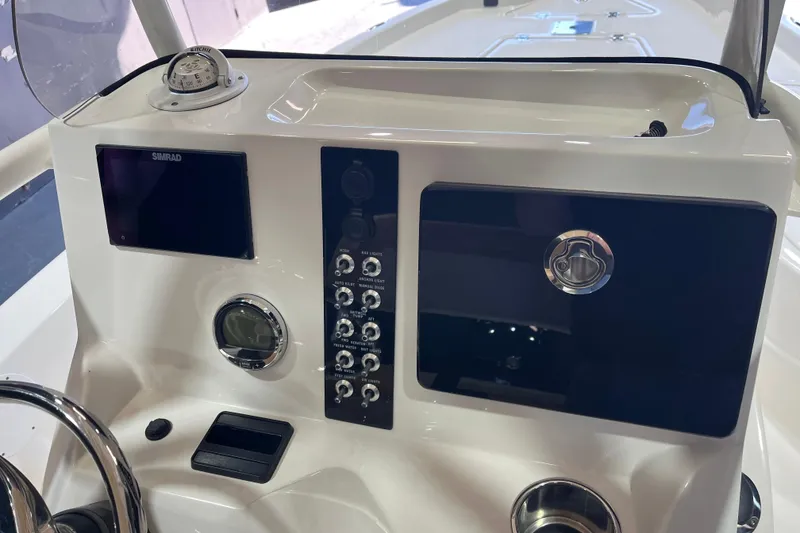 Slide: The Image of 2023 NauticStar 215 XTS boat console with navigation controls and display. - 18