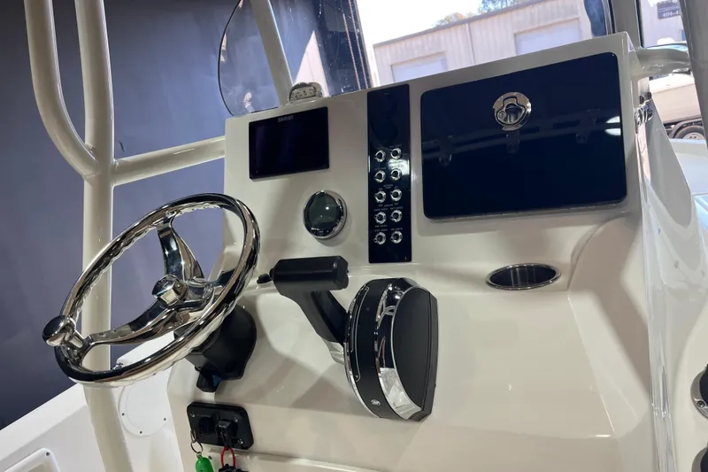 Slide: The Image of 2023 NauticStar 215 XTS boat console with steering wheel and control panel. - 7