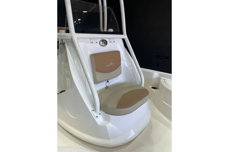 Slide: The Image of 2023 NauticStar 215 XTS boat seat with tan cushion and white frame. - 8