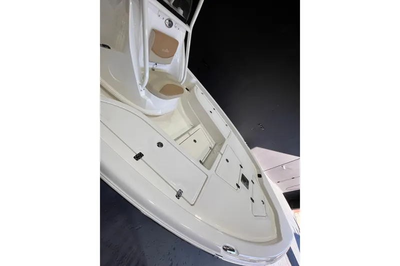 Slide: The Image of 2023 NauticStar 215 XTS boat deck with storage compartments and seating. - 9