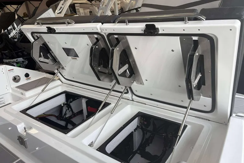 Slide: The Image of 2026 Monterey Elite 30 OB boat storage compartments open, showcasing interior design and functionality. - 10