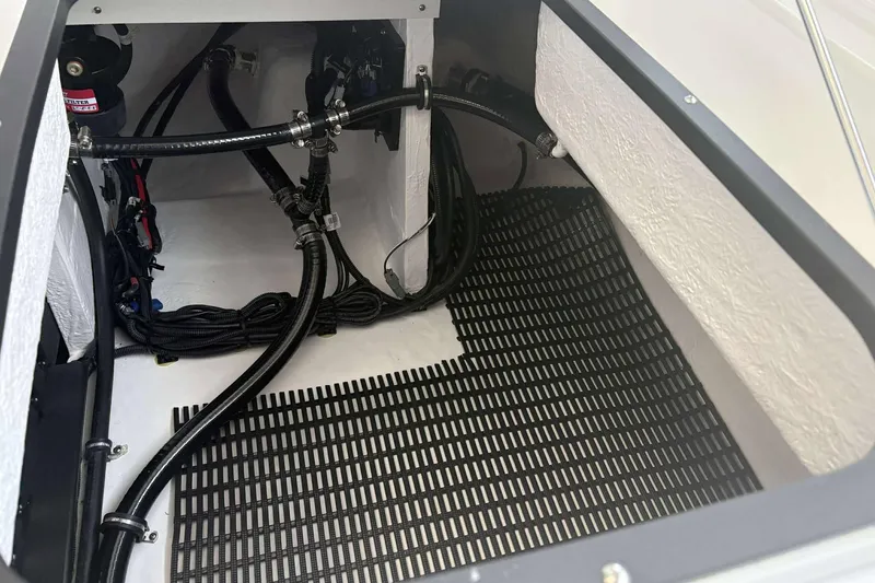 Slide: The Image of Engine compartment of 2026 Monterey Elite 30 OB boat with visible wiring and hoses. - 18