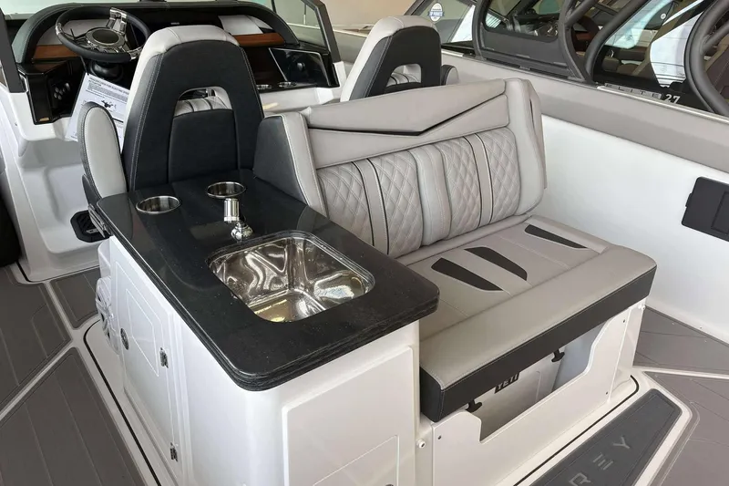 Slide: The Image of 2026 Monterey Elite 30 OB boat interior with luxury seating and built-in sink. - 20
