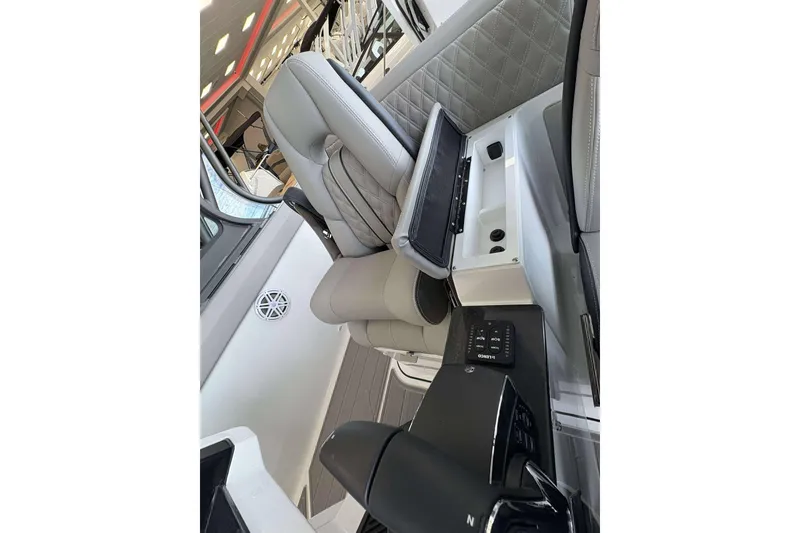 Slide: The Image of Interior of 2026 Monterey Elite 30 OB boat with luxurious seating and modern controls. - 23