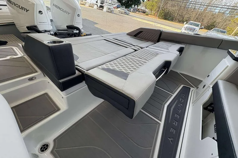 Slide: The Image of 2026 Monterey Elite 30 OB boat interior with luxurious seating and Mercury engines. - 25