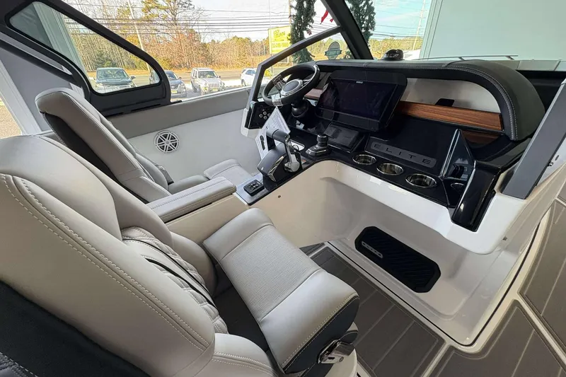 Slide: The Image of Interior of 2026 Monterey Elite 30 OB boat with modern dashboard and seating. - 28