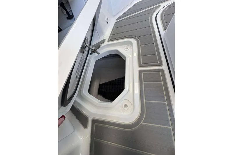 Slide: The Image of 2026 Monterey Elite 30 OB boat storage compartment with sleek gray decking. - 32
