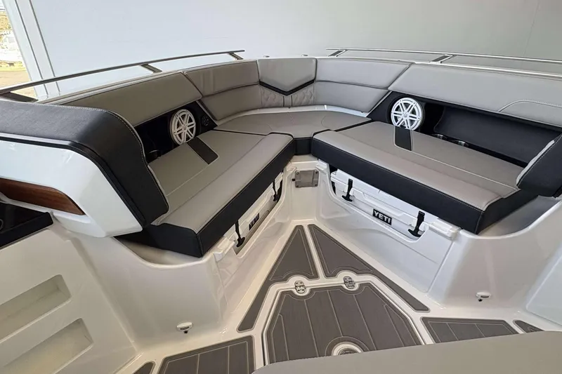 Slide: The Image of 2026 Monterey Elite 30 OB boat interior with cushioned seating and built-in speakers. - 33