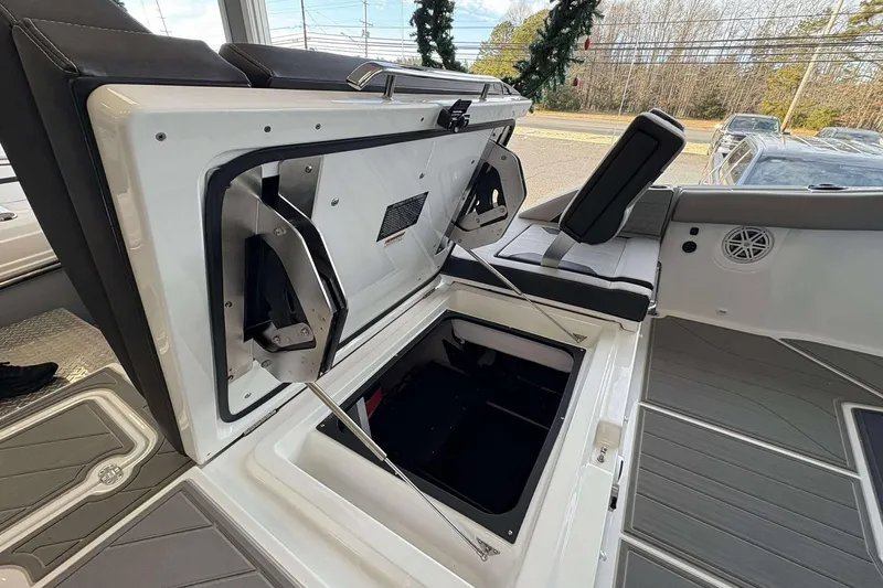 Slide: The Image of 2026 Monterey Elite 30 OB boat interior with open storage compartment and seating. - 34