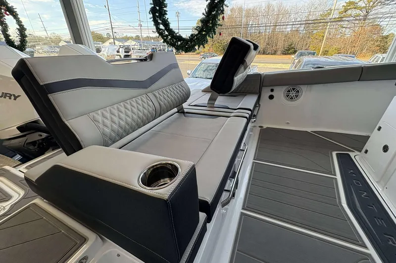 Slide: The Image of 2026 Monterey Elite 30 OB boat interior with luxurious seating and cup holder. - 40