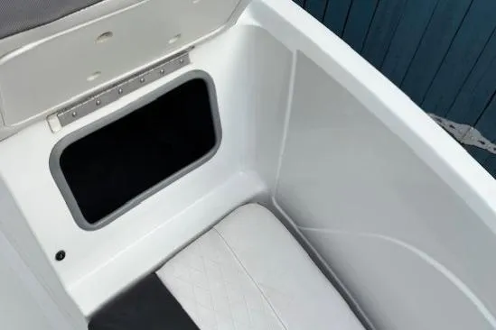 Slide: The Image of 2019 Tahoe 500 TS boat storage compartment with cushioned seating and open hatch. - 10