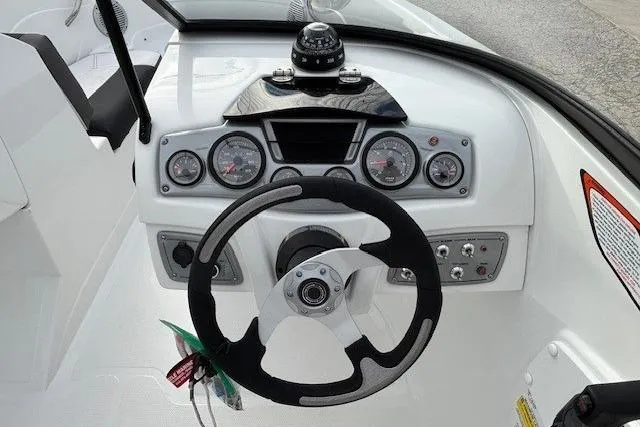 Slide: The Image of Steering console of a 2019 Tahoe 500 TS boat with gauges and compass. - 14