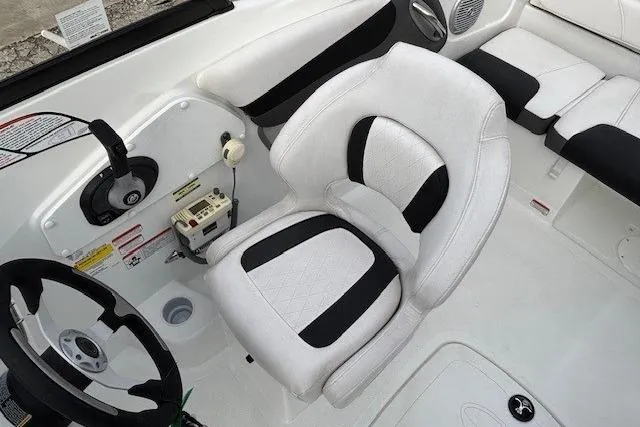 Slide: The Image of 2019 Tahoe 500 TS boat interior with white and black seating and steering wheel. - 17
