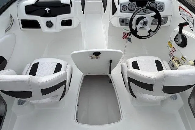 Slide: The Image of 2019 Tahoe 500 TS boat interior with steering wheel and white seating. - 20