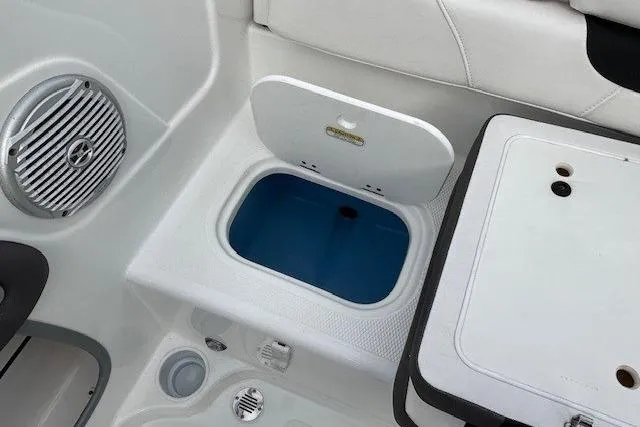Slide: The Image of 2019 Tahoe 500 TS boat interior with storage compartment and speaker. - 23