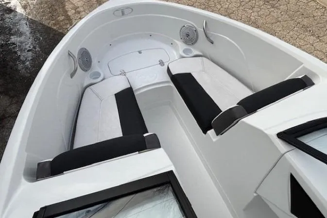 Slide: The Image of 2019 Tahoe 500 TS boat interior with white and black seating, speakers, and cup holders. - 7