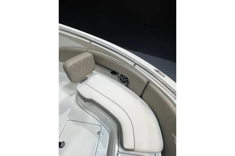 Slide: The Image of 2023 Crownline 220 CC Finseeker boat interior with cushioned seating and speaker. - 15