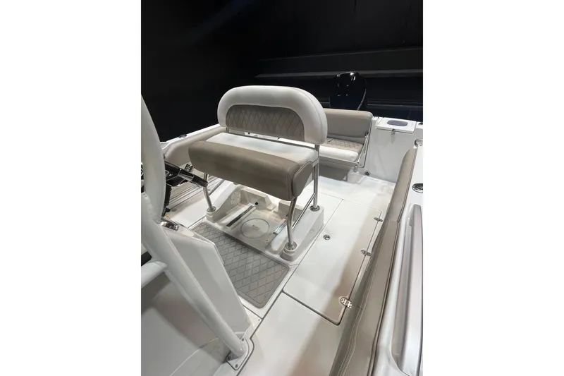 Slide: The Image of 2023 Crownline 220 CC Finseeker boat interior with cushioned seating and sleek design. - 17
