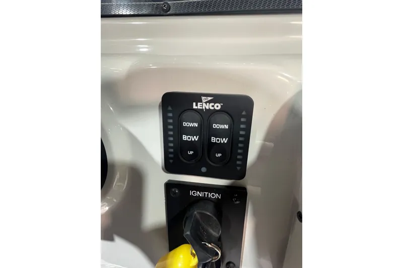 Slide: The Image of Control panel of 2023 Crownline 220 CC Finseeker boat with Lenco trim tab switches. - 20