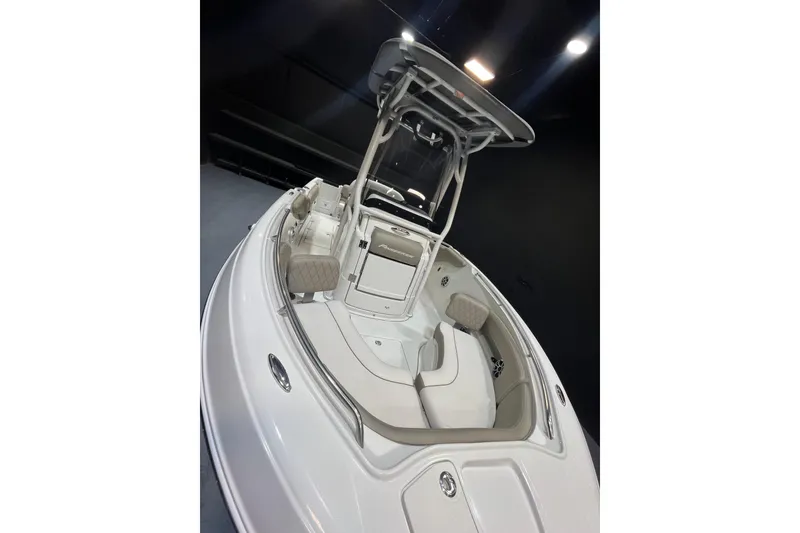 Slide: The Image of 2023 Crownline 220 CC Finseeker boat interior with seating and console, under studio lighting. - 21