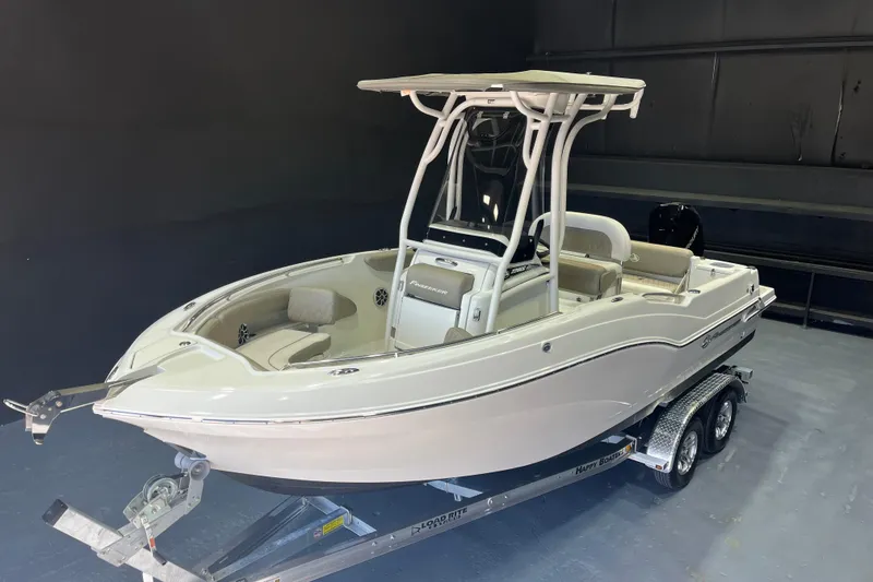 Slide: The Image of 2023 Crownline 220 CC Finseeker boat on trailer in showroom. - 23