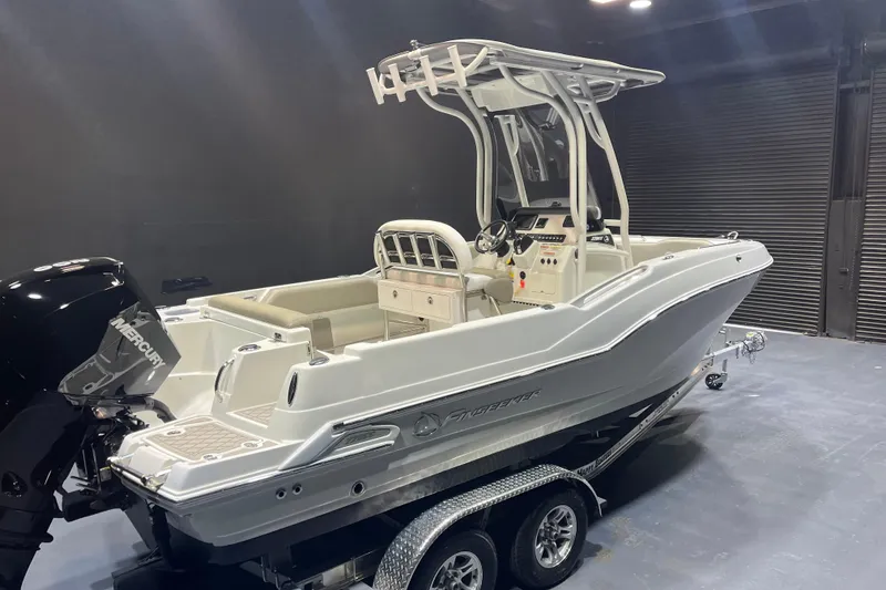 Slide: The Image of 2023 Crownline 220 CC Finseeker boat on trailer in showroom setting. - 4