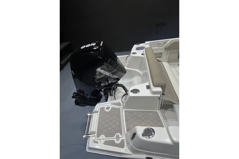 Slide: The Image of 2023 Crownline 220 CC Finseeker boat with Mercury engine, featuring sleek seating and deck design. - 5