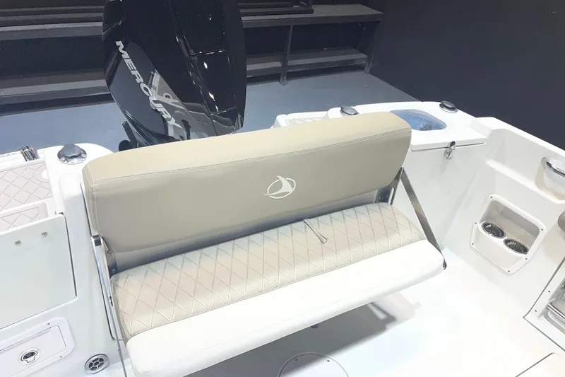 Slide: The Image of 2023 Crownline 220 CC Finseeker boat interior with cushioned seating and Mercury engine. - 6