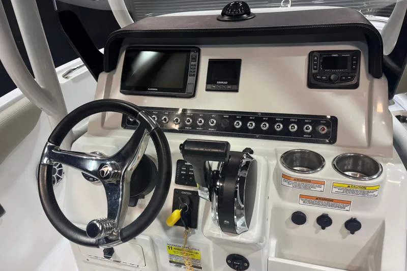 Slide: The Image of 2023 Crownline 220 CC Finseeker dashboard with steering wheel, controls, and navigation displays. - 8