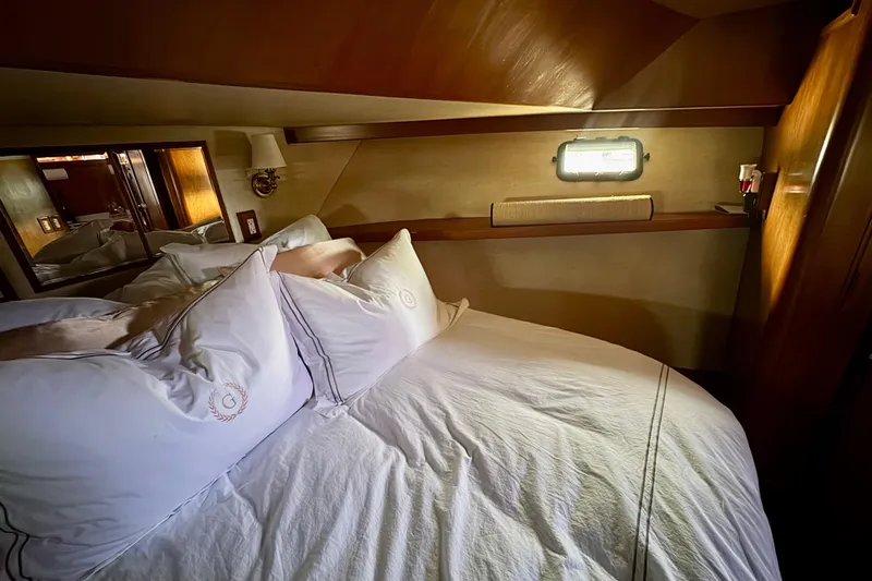 Slide: The Image of Luxurious bedroom interior of 1988 Carmague 48 CPMY yacht with elegant bedding. - 13