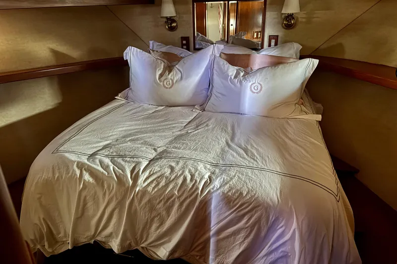 Slide: The Image of Luxurious bedroom interior of 1988 Carmague 48 CPMY yacht with elegant bedding. - 16